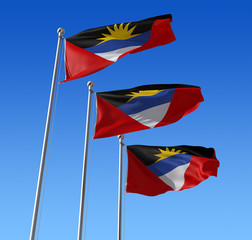 Three flags of Antigua and Barbuda  against blue sky.