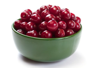 Bowl with ripe cherries. Isolated on a white background.