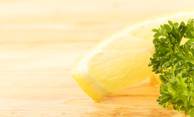 lemon wedge and parsley on a cutting board