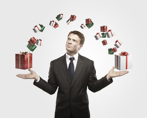 Young  businessman with a gift boxes in his hands