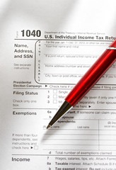 Obraz premium Tax form and a red pen