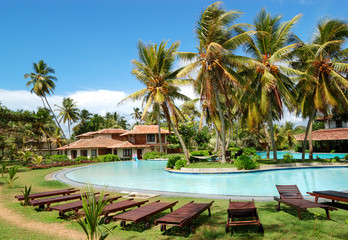 Fototapeta na wymiar Swimming pool near villas at the popular hotel, Bentota, Sri Lan