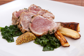 Sliced pork with spinach and parsnips
