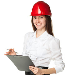 Successful smiling young woman in hardhat holding clipboard and