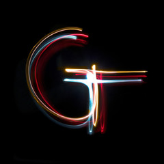 Letter G made from brightly coloured neon lights