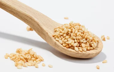 Foto op Plexiglas Sesame grains in small wooden spoon © ecobo