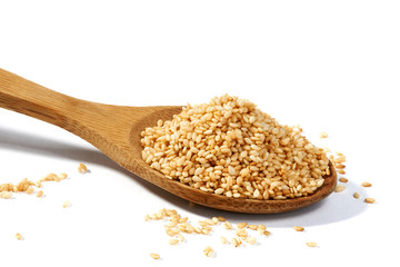 Sesame grains in large wooden spoon