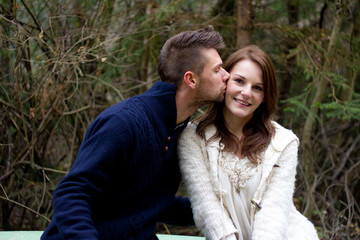 Man kissing woman on the cheek