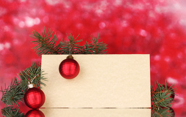 Fototapeta na wymiar blank postcard, Christmas balls and fir-tree on red background