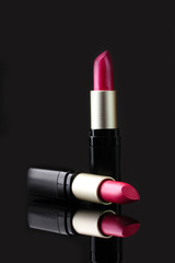 Two lipsticks isolated on black