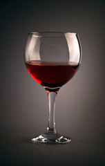 Glass of red wine on grey background