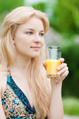 Smiling woman drinking orange juice