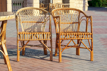 Two wicker chairs and a table
