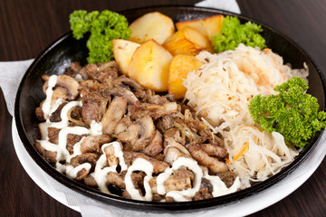 meat with potatoes in the pot