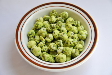 wasabi green pea snack balls isolated on the bowl