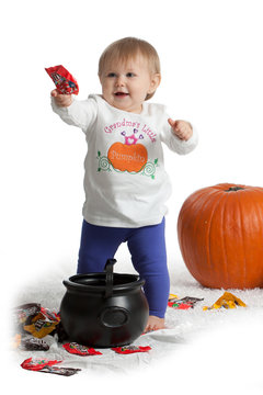 Girl holding candy with pumpkins
