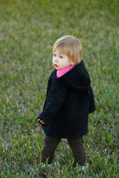 Girl in dark Jacket on Grass
