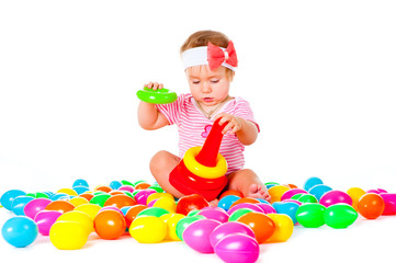 Obraz premium Baby girl playing in the balls