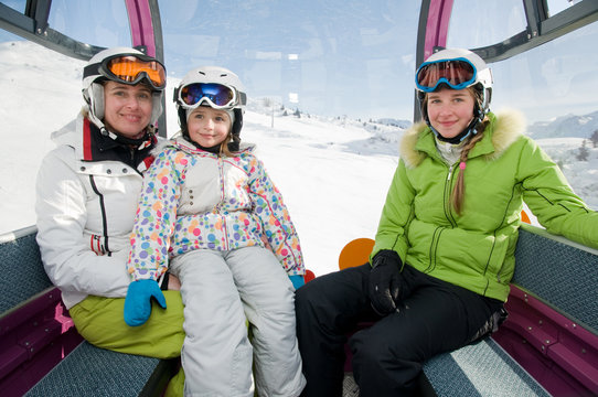 Ski vacation - skiers in cable car