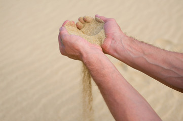 Sand running through hands