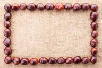 chestnuts frame on fabric texture background