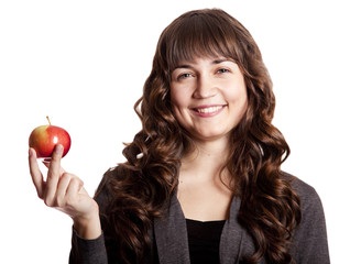 Brunette girl with apple in hand.