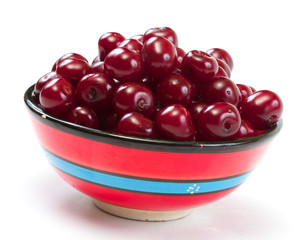 Bowl with ripe cherries. Isolated on a white background.