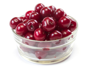 Bowl with ripe cherries. Isolated on a white background.