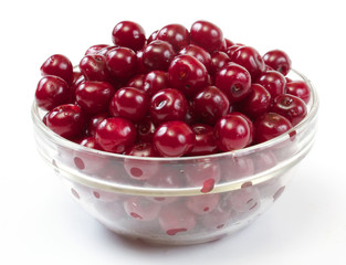 Bowl with ripe cherries. Isolated on a white background.