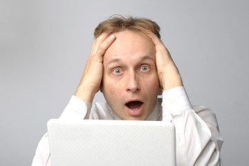 Portrait of middle-aged man with a white laptop computer