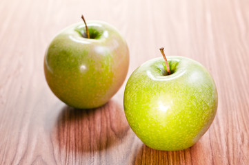 Two apples on wooden table