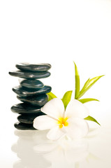 Obraz na płótnie Canvas Balanced zen stones with flower and bamboo