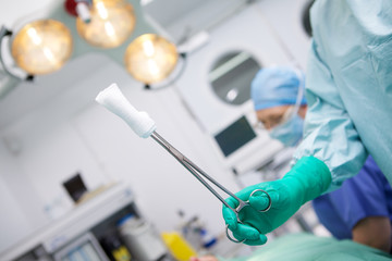 Surgeon holding swab during operation