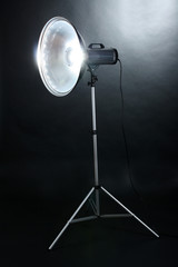 Studio flash with beauty dish on grey background