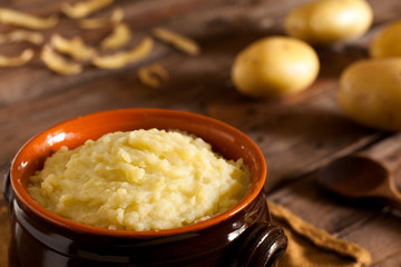 Mashed Potatoes in Terracotta Pot on Wood