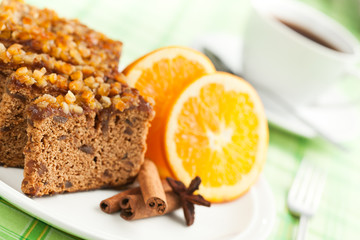 Gingerbread with orange and cup of coffee or tea.