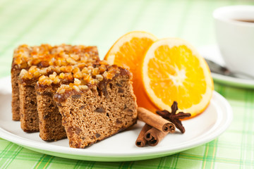 Gingerbread with orange and cup of coffee or tea.