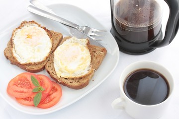 Breakfast of eggs on toast and coffee