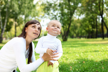 Young mother with her son in summer park