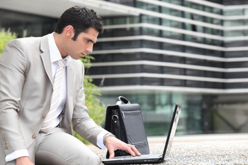 Man using a laptop outside