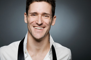 Young confident businessman in white shirt
