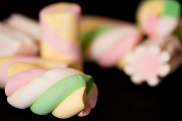 sweet colorful marshmallows on black background