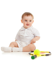 adorable child floor and playing with tennis racket and ball ove