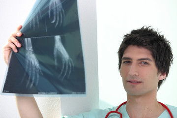 Young male medic examining Xrays of hands