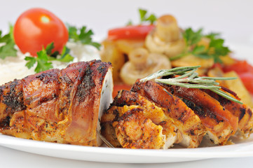 Closeup view of roasted meat served on plate with vegetables