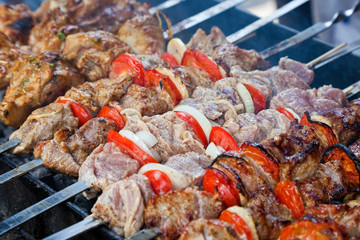 Juicy slices of meat with sauce prepare on fire