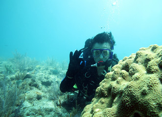 Male scubadiver on exotic coral reefs