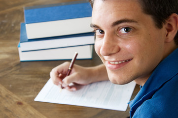 Teen boy filling out college application