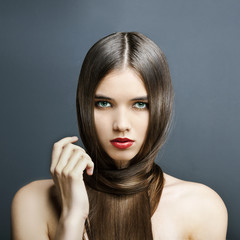 Fototapeta premium beautiful girl with perfect skin, red lipstick and long hair