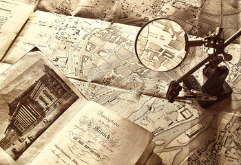 Old map and magnifying glass in sepia